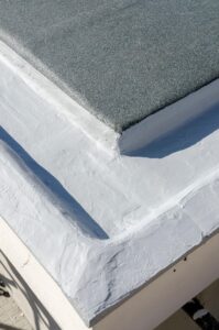 Roof waterproofing and reflective coating detail at a terrace parapet junction